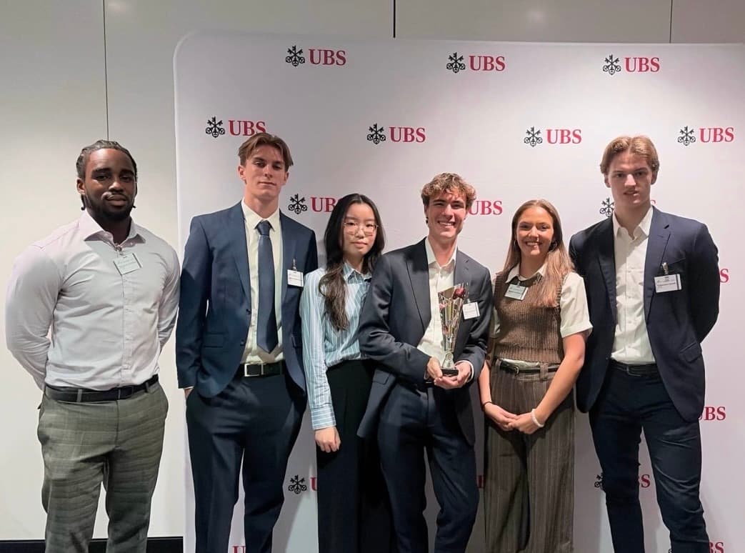 The six-person Speedy 6 team with a trophy at Meet UBS in London